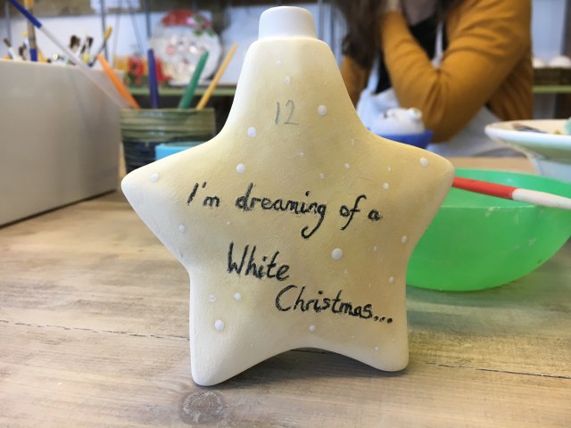 Writing on a painted bauble at Tarka Pottery